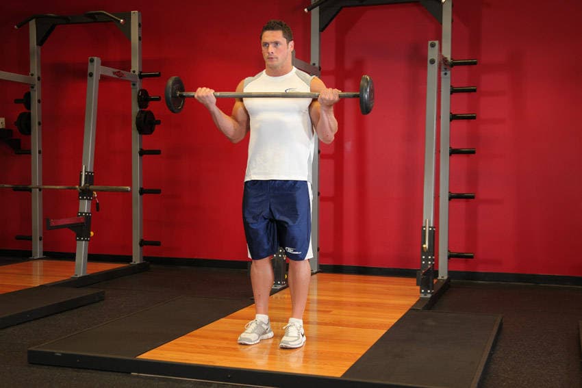 Wide-Grip Standing Barbell Curl — النهاية